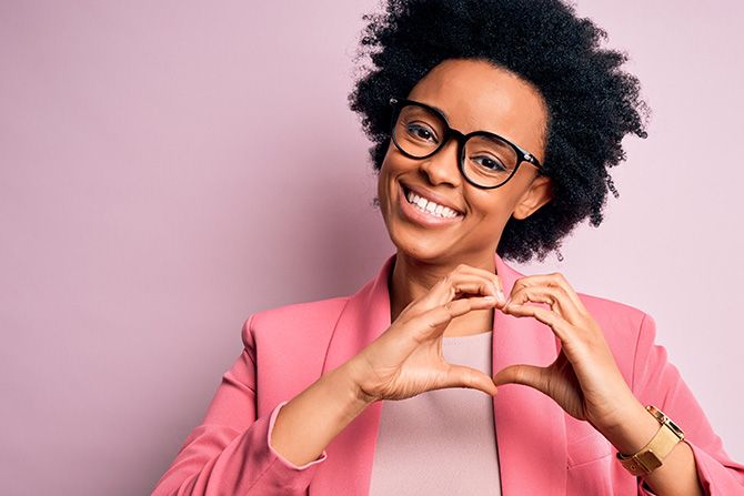 Fraud Victim Support; Person making a heart shape gesture.