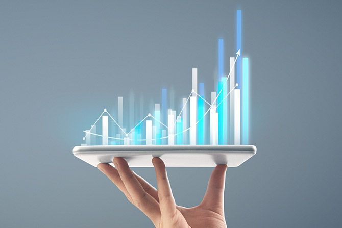 Portfolio Management: Lies and Statistics; A hand holds a tablet with holographic bar and line graphs above it, representing data analysis and growth.