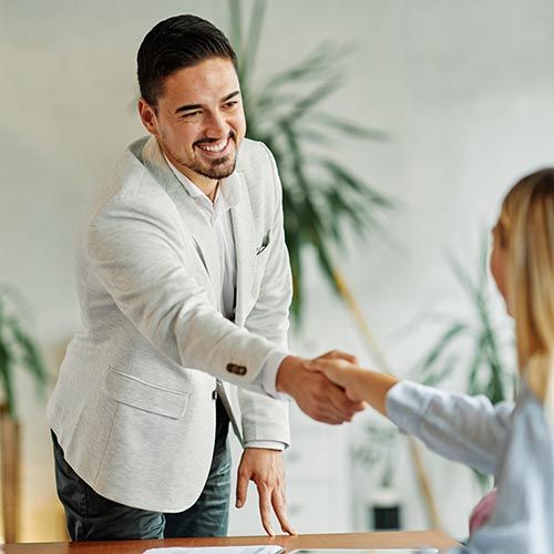 Man shaking hands with woman